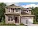 Charming two-story home boasts a welcoming front porch and a convenient two-car garage at 10100 Ballast Dr, Orlando, FL 32827