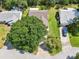 Aerial view of a home showing the roof, mature trees, and surrounding neighborhood at 1011 Dundee Cir, Leesburg, FL 34788