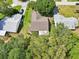 Aerial view of a home featuring a well-manicured lawn and mature trees offering shade and privacy at 1011 Dundee Cir, Leesburg, FL 34788