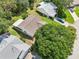 Aerial perspective of the house, showcasing its backyard, screened-in patio, and position in the neighborhood at 1011 Dundee Cir, Leesburg, FL 34788