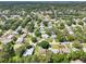 Wide aerial shot of a suburban neighborhood, highlighting the community layout and green spaces at 1011 Dundee Cir, Leesburg, FL 34788