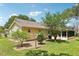 Backyard view showing sunroom and landscaping at 1011 Dundee Cir, Leesburg, FL 34788