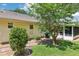 Backyard view showing sunroom and landscaping at 1011 Dundee Cir, Leesburg, FL 34788