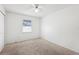 Bedroom featuring carpet flooring, a ceiling fan, and a window that allows for natural lighting at 1011 Dundee Cir, Leesburg, FL 34788