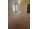 Spacious bedroom with carpet, ceiling fan, a bathroom, and large window at 1011 Dundee Cir, Leesburg, FL 34788