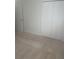 Carpeted bedroom features ample closet space for storage at 1011 Dundee Cir, Leesburg, FL 34788