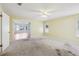 Spacious bedroom featuring carpet floors, a ceiling fan, and an open door to another room at 1011 Dundee Cir, Leesburg, FL 34788
