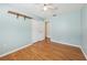 Bedroom featuring hardwood floors, a ceiling fan, and a large closet with double doors at 1011 Dundee Cir, Leesburg, FL 34788