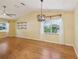 Open dining area with laminate wood flooring, open shelving, vaulted ceilings, and modern light fixture at 1011 Dundee Cir, Leesburg, FL 34788