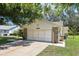 Charming single-story home showing driveway and a two car garage at 1011 Dundee Cir, Leesburg, FL 34788