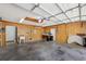 Well-lit garage with pegboard walls, storage, and garage door mechanism at 1011 Dundee Cir, Leesburg, FL 34788