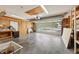 Spacious garage with workbench, pegboard, and partially open door at 1011 Dundee Cir, Leesburg, FL 34788