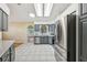 A spacious kitchen features stainless steel appliances, gray cabinets, and ample countertop space for cooking and food preparation at 1011 Dundee Cir, Leesburg, FL 34788