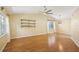 Bright living room with high ceilings, hardwood floors, large windows and decorative shelves at 1011 Dundee Cir, Leesburg, FL 34788
