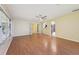 Spacious living room featuring hardwood floors, a ceiling fan, and bright lighting at 1011 Dundee Cir, Leesburg, FL 34788