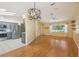 Open living space featuring modern kitchen, dining area, and laminate wood flooring at 1011 Dundee Cir, Leesburg, FL 34788