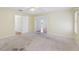 Spacious main bedroom with carpet and multiple entrances at 1011 Dundee Cir, Leesburg, FL 34788