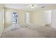 A spacious main bedroom with carpet, a ceiling fan and ensuite bathroom at 1011 Dundee Cir, Leesburg, FL 34788