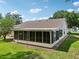 Enclosed back porch offers a relaxing space with screens and view of the backyard at 1011 Dundee Cir, Leesburg, FL 34788