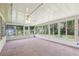 Bright sunroom featuring tile flooring, a ceiling fan, and lots of windows at 1011 Dundee Cir, Leesburg, FL 34788