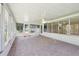 Bright sunroom featuring tile flooring, a ceiling fan, and lots of windows at 1011 Dundee Cir, Leesburg, FL 34788