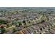 Expansive aerial view of a well-maintained neighborhood with lush landscaping and uniform rooftops, perfect for serene suburban living at 1014 Nash Loop, The Villages, FL 32162