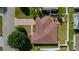 Aerial view of a private home with a patio, lawn, and manicured landscaping, bordered by a white fence at 1014 Nash Loop, The Villages, FL 32162