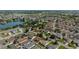 Aerial shot of a community showcasing homes surrounding a tranquil lake and golf course, offering a picturesque and active lifestyle at 1014 Nash Loop, The Villages, FL 32162