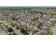 Sweeping aerial view of a residential community with meticulously maintained homes and lush landscaping in a serene setting at 1014 Nash Loop, The Villages, FL 32162