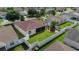 Aerial view of a fenced backyard featuring a screened lanai and a cozy patio, surrounded by lush green lawn at 1014 Nash Loop, The Villages, FL 32162