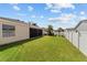 Large backyard with a well-maintained lawn and landscaping at 1014 Nash Loop, The Villages, FL 32162