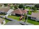 Aerial view of a fenced backyard featuring a screened lanai and a cozy patio, surrounded by lush green lawn at 1014 Nash Loop, The Villages, FL 32162