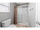 Neutral bathroom featuring a toilet, large shower, window, and tile floors at 1014 Nash Loop, The Villages, FL 32162