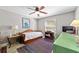 Bedroom with a wooden daybed, desk, and colorful rug at 1014 Nash Loop, The Villages, FL 32162