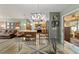 Dining area showcasing a modern light fixture and view to an adjacent seating area at 1014 Nash Loop, The Villages, FL 32162
