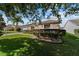Well-kept home with verdant lawn, landscaped beds, and a paved driveway leading to a single-car garage at 1014 Nash Loop, The Villages, FL 32162