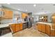Bright kitchen boasts stainless steel appliances, wooden cabinets, tile floors, and an adjacent dining area at 1014 Nash Loop, The Villages, FL 32162