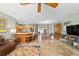 Spacious living room featuring tile floors, a ceiling fan, and an open-concept design at 1014 Nash Loop, The Villages, FL 32162