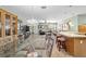 Open floor plan with tile flooring combining the dining and living areas, with ample seating at 1014 Nash Loop, The Villages, FL 32162