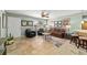 Spacious living room featuring tile floors, a ceiling fan, and ample natural light at 1014 Nash Loop, The Villages, FL 32162