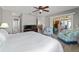Bright main bedroom leads to the ensuite bathroom, living area, and outdoor patio at 1014 Nash Loop, The Villages, FL 32162