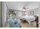 Tranquil main bedroom features stylish chairs, a ceiling fan, and ample natural light at 1014 Nash Loop, The Villages, FL 32162