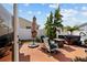 Private patio area featuring outdoor seating, a hot tub, and lush landscaping at 1014 Nash Loop, The Villages, FL 32162