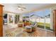 Bright sunroom with tile flooring, comfortable seating, and views of the backyard at 1014 Nash Loop, The Villages, FL 32162