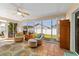 Sunroom with comfortable seating, tile flooring, and view of backyard at 1014 Nash Loop, The Villages, FL 32162