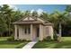 Charming single-story home with a covered porch, neutral stucco, and a well-manicured lawn with tropical landscaping at 10326 Pearson Ave, Orlando, FL 32827