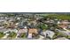 Aerial view of the home, displaying a well-maintained yard, screened-in pool, and proximity to community amenities at 1175 Johnston Path, The Villages, FL 32162