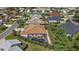 Aerial view of the home highlighting a private, screened-in pool area, lush landscaping, and a brick-paved driveway at 1175 Johnston Path, The Villages, FL 32162