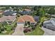 Aerial view of a well-manicured home featuring lush landscaping and a screened pool at 1175 Johnston Path, The Villages, FL 32162