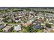 Expansive aerial view of a well-planned community featuring lush landscaping, numerous homes, and community greenspace at 1175 Johnston Path, The Villages, FL 32162